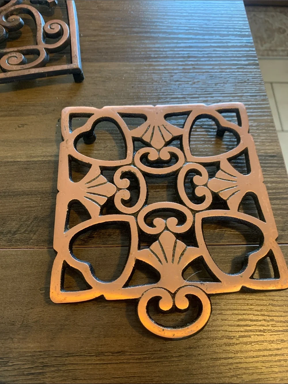 The Pampered Chef Copper-Tone Ornate Trivet Set.